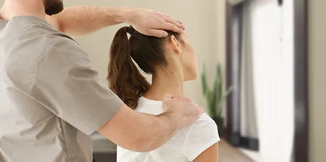 Chiropractor examining a patient’s neck